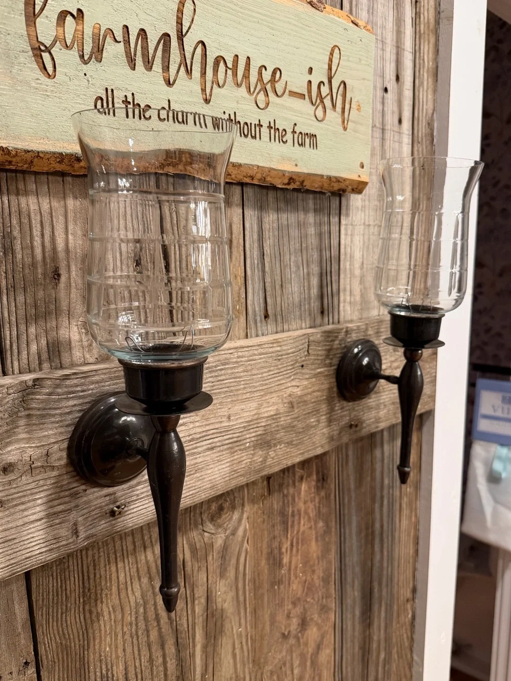 Pair of farmhouse dark bronze-toned metal candle sconces with clear glass
